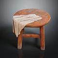 Round Wooden Stool with a Beige Cloth Draped Over the Seat and Solid Legs