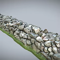Natural Stacked Stone Wall With Green Grass Base In Outdoor Landscape