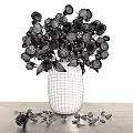 Black Vase With Red And Yellow Roses On Table With Scattered Petals