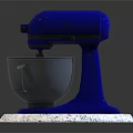 Blue Stand Mixer Kitchen Appliance With Stainless Steel Bowl On White Marble Countertop