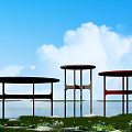 Round Coffee Tables In Three Different Colors With Blue Sky White Clouds Grass And Water
