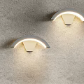 Pair of Modern Arched Wall Lamps Mounted On Gray Wall With Illuminated Design