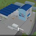 Industrial Factory Building With Blue Roof Surrounded by Green Trees and Operational Vehicles