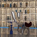 Modern Sculptural Single Chair With Metallic Glossy Finish Decorative Figurines And Textured Wall