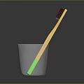 Children's Toothbrush With Yellow Handle Green Bottom Brown Bristles In Glass Cup
