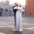 Newlywed Couple Embracing In Front Of Venice Landmark