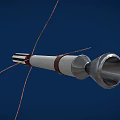 Cylindrical Device With Black White Stripes Red Rings Metal Tip And Thin Wires