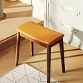 Modern Stylish Stool With Orange Leather Seat And Dark Wooden Legs In Interior Space