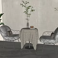 Round Table and Gray Cushioned Chairs with Black Metal Frames Tablecloth Vase Cup Green Plants