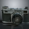 Vintage Silver And Black Electronic Camera With Lens And Knobs