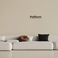White Three Seater Sofa with White Tan and Black Cushions on Beige Poliform Wall