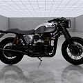 Vintage Silver and Black Motorcycle with Black Leather Seat on Industrial Gray Concrete Floor