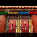 Traditional Storefront Entrance with Red Double Doors Golden Decorations and Colorful Tassels
