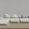 Minimalist Sectional Sofa With Light Pillows And Floor Lamp On Wooden Floor In Bright Room