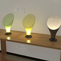 Artistic Craft Table Lamps With Green Yellow White Shades And Black Bases On Wooden Desk