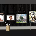 Different Style Paintings Hanging On Dark Wall With Light Decorative Line And Pen Holder