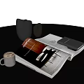 Decorative Ornament Set with Black Jug Silver Cup Open Magazine Coffee Latte Art on Tabletop