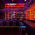 Vibrant Bar With E PARTY Neon Sign Shelves Bottles Counter Stools And Purple Red Lighting