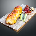 Fresh Braided Bread Served with Ham Walnuts and Cucumber Sticks on Wooden Board