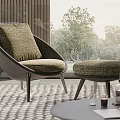 Round Outdoor Table With Wicker Chair Cushioned Seat Plants And Books Near Trees