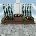 Decorative Garden Planters With Tall Green Plants Pink Flowers Against White Fence Stone Pavement