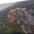 Rusty Steel Cantilever Stairway And Glass Viewing Platforms Mounted On Steep Rugged Mountain Cliffside