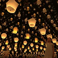 Numerous Bright Sky Lanterns Illuminated Night Scene With People Releasing Lights