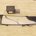 Traditional Chinese Musical Instrument And Art Supplies Featuring Guzheng And Calligraphy Scroll
