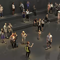 Group of People Gathered in Gray Indoor Space Standing Sitting Taking Photos and on Scooter