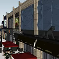 Modern Commercial Street Featuring Glass Facade Outdoor Seating And Shop Signs