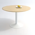 Round Wooden Coffee Table With White Base And Plate With Lemons
