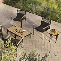 Outdoor Patio Woven Black Lounge Chairs With Wooden Tables And Green Plants
