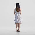 Elegant Woman In Sleeveless Polka Dot Dress With Beige Handbag And High Heels Standing Gracefully