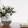 Silver Gray Gradient Vase With White Flowers And Green Leaves On Wooden Table