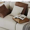 Brown And White Decorative Pillows On Beige Sofa With Open Magazine