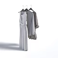 Neutral Colored Clothing Hanging on Hangers Including Long Dress and Long Sleeve Tops