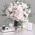 Pink Roses And Eucalyptus Leaves In Black Vase With Deer Figurines Picture Frames And Candles