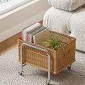 Wicker Side Table With Wheels Holding Books And Potted Plant Beside Sofa