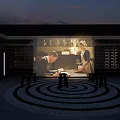 Traditional Courtyard Featuring Spiral Patterned Ground And Projection Of People Under Evening Lighting