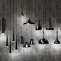Black Pendant Lights With Various Designs Hanging From Gray Ceiling In Different Shapes And Sizes