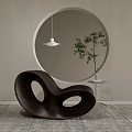 Unique Curved Brown Leisure Chair With Oval Cutouts Round Mirror Green Plant Gray Carpet