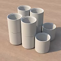 Construction Site Featuring Stacked Gray Concrete Cylinders With Green Vegetation 3d model