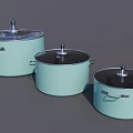Three Light Green Cooking Pots With Black Lids And Silver Handles