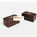 Two Carved Wooden Boxes With Golden Accents And Intricate Decorative Design
