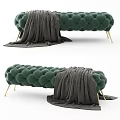 Plush Green Tufted Ottoman With Gold Legs And Gray Throw Blanket
