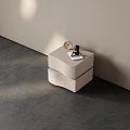 Modern Minimalist Bedside Table With Round Clock And Small Black Sculpture Against Light Colored Wall