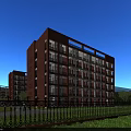 Red Brick Multi Storey School Building In Campus With Blue Sky Green Lawn And Pedestrians
