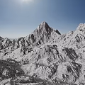 Snowy Mountain Terrain With Tall Snow-Covered Peaks Clear Blue Sky And Bright Sun