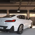 White Sleek Sporty SUV Parked In Interior Garage With Roller Doors And Black Alloy Wheels