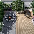 Outdoor Landscape Seating Space With Fire Pit Green Plants And Wooden Deck